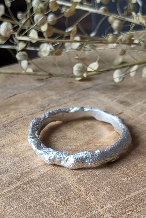 Anello artigianale in argento 925 con texture materica granulosa e finitura opaca.