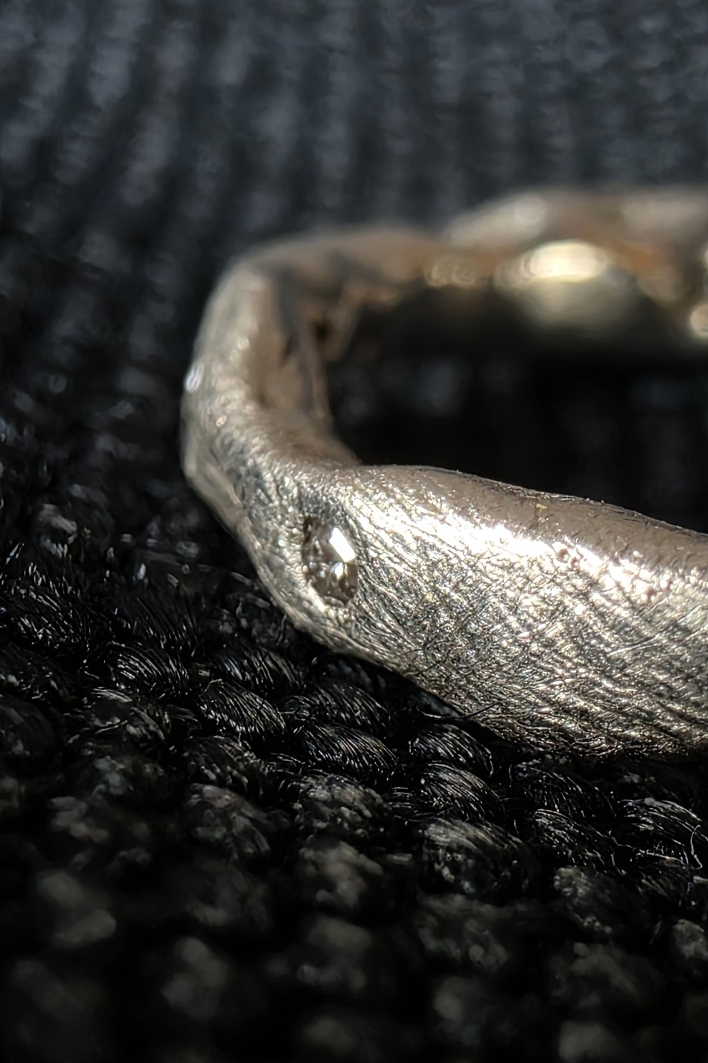 Macro dell'anello Frammento di Luce Caleidos: texture materica in argento 925 con diamante naturale incastonato a mano